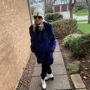 Fun fur coat in sapphire blue by Adrienne Landau. Dyed Asiatic raccoon. Size S